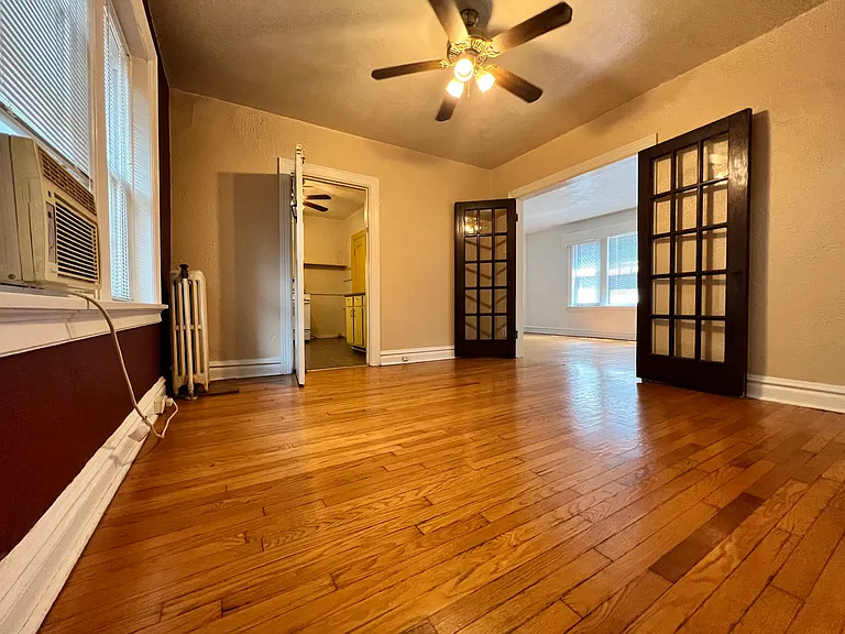 This room has Western views overlooking the community garden and the shared yard. It's a beautiful view of luscious greenery. 
Both the kitchen and bedroom entrance are located through this room.