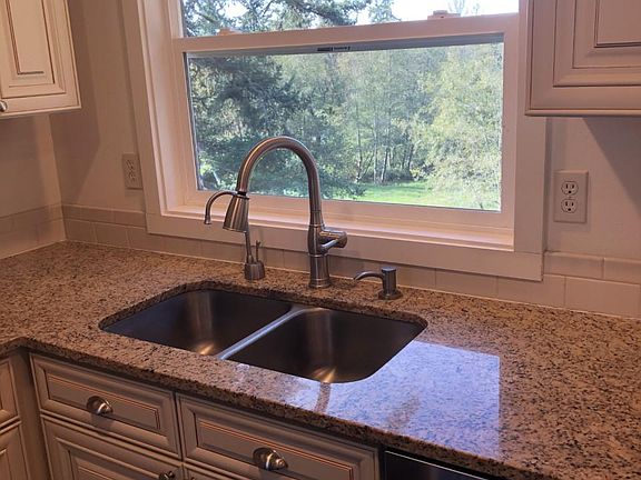 Double sink with window looking out to trees