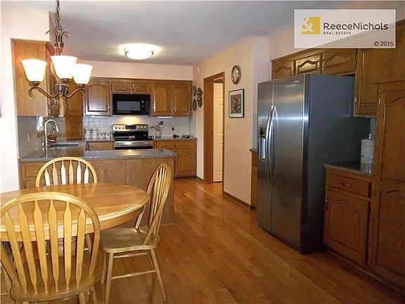 Lots of cabinets. Side by Side Stainless Steel Refrigerator.