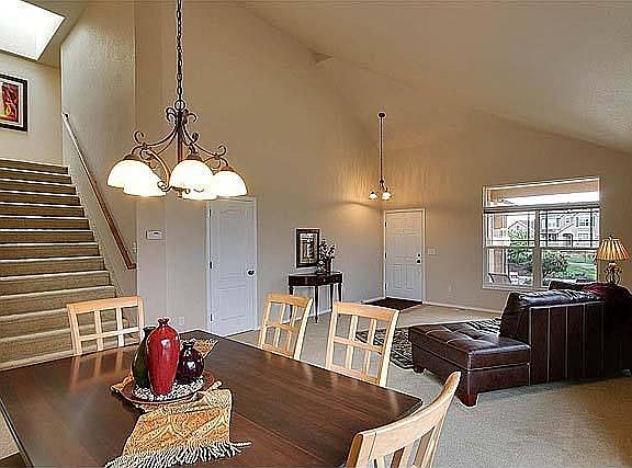 Wide stairwell to the upper level with dual handrails.