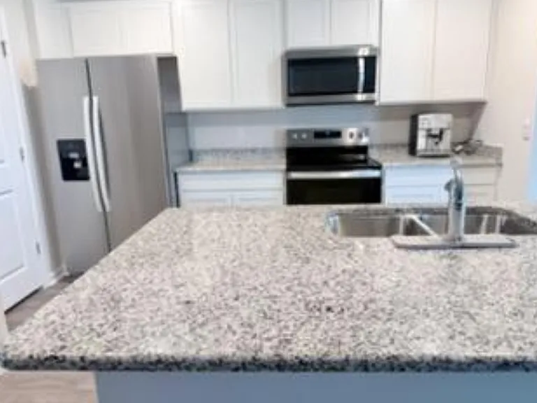 Great kitchen with a stainless steel refrigerator, built in microwave & lots of cabinet space!