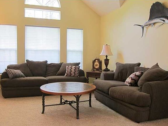 Living Room. This bright living room is the perfect place to greet your guests or stretch out beside the windows with a good book.