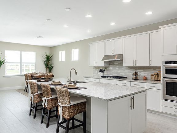 Model Representation Kitchen with built-in stainless gas appliances and 42 white maple cabinets
