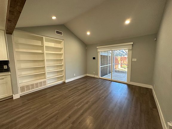 Living room with cathedral ceiling and built in bookcase