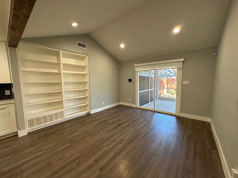 Living room with cathedral ceiling and built in bookcase