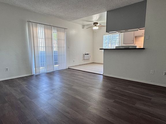 Spacious living area with new vinyl plank flooring, blinds and paint!