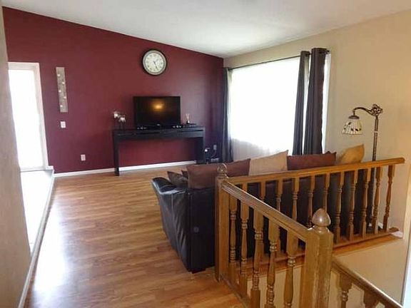 Upper level living room. Oak spindle rails.  NEW windows throughout the home!  This is huge!