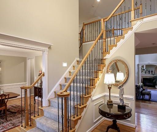 Two story foyer, oak & wrought iron staircase
