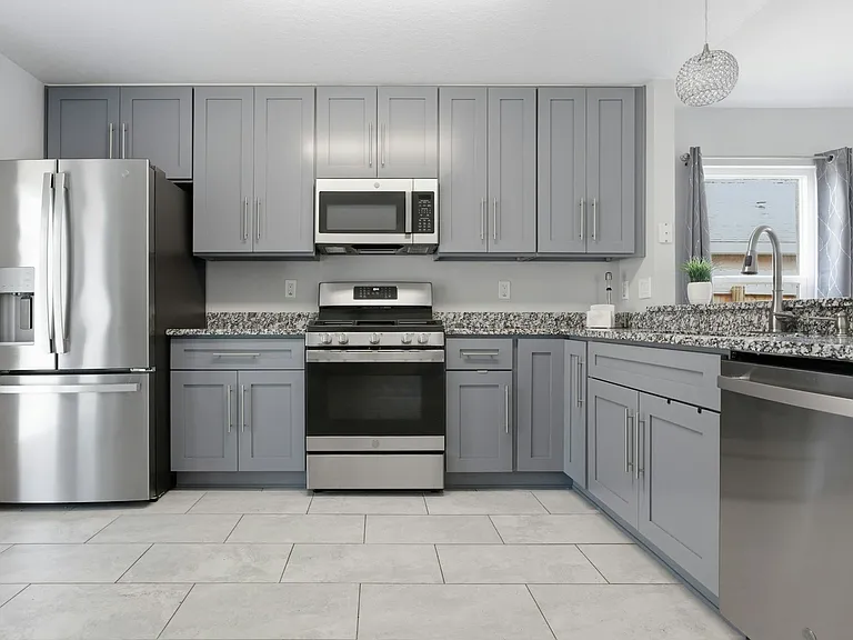 Kitchen with all stainless steel appliances, gas range soft close cabinets & granite counter tops