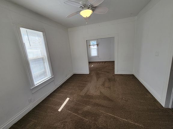 Living room looking toward dining room through opening; bedroom is on the right
