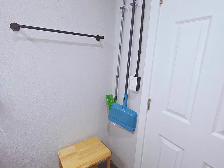 Wall-mounted mop and broom holder for easy cleaning storage