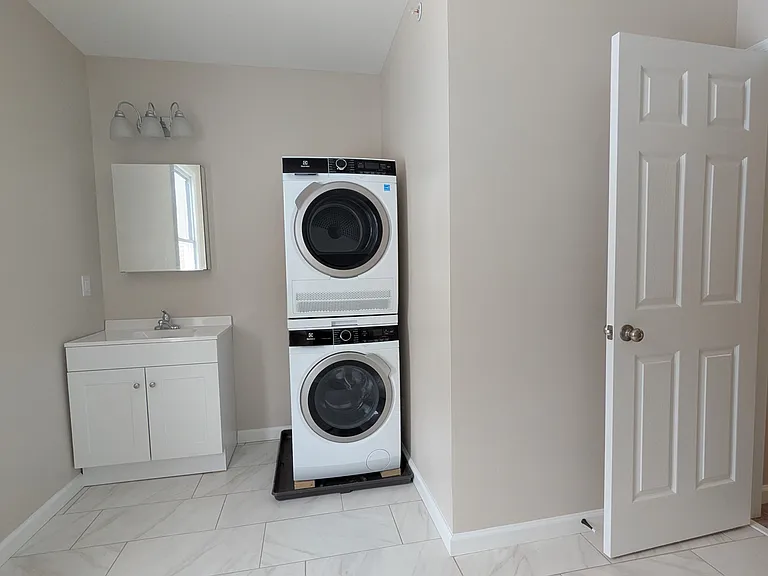 Washer / dryer included in the apartment and located conveniently in the bathroom