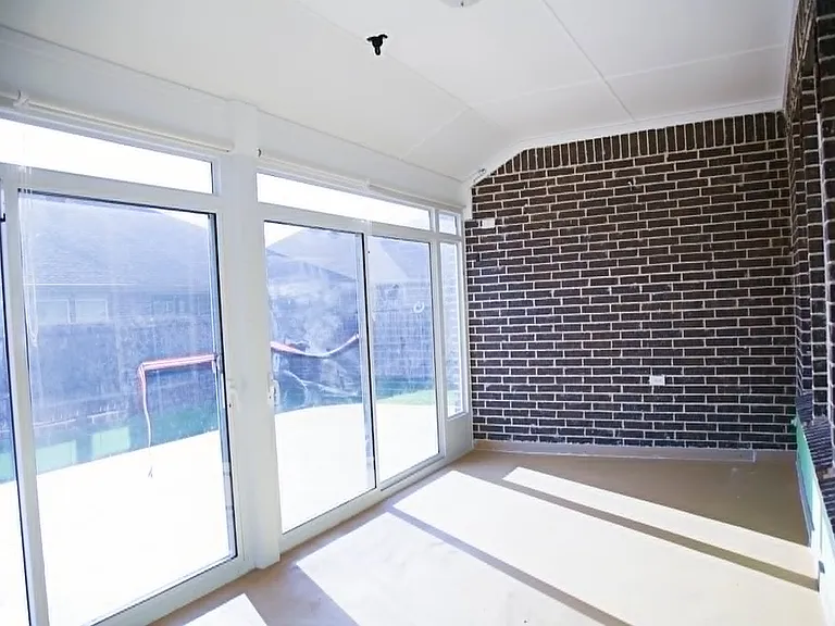 Sunroom enclosed with siding door and screen. There is a portable AC connection for a air conditioning.