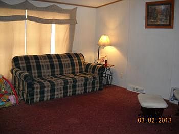 Lots of space offered here in this roomy living room with a huge front window to gaze out, that also offers loads of light.