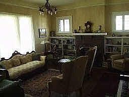 Comfortable living area with fireplace and built in bookshelves