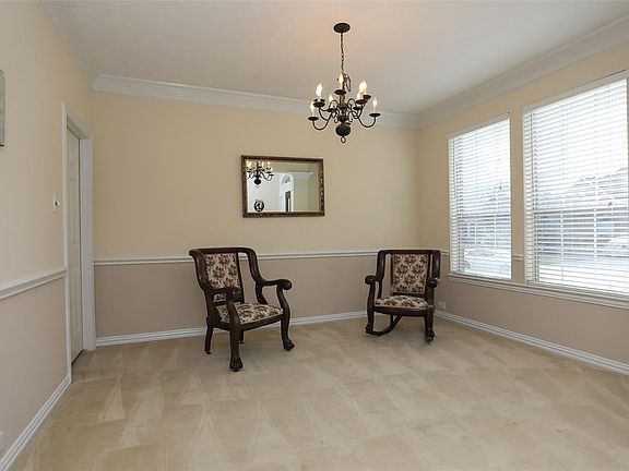 Formal dining room has chair molding and crown molding. Easy access to the kitchen.