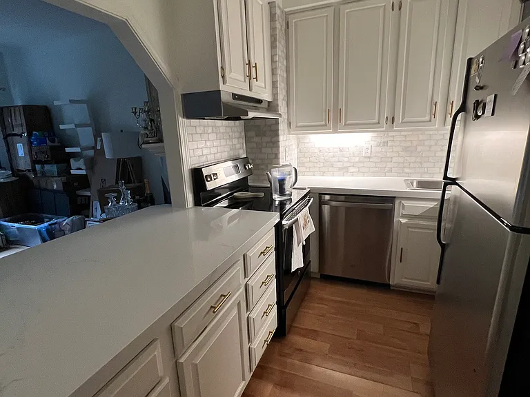 Recently updated backsplash and countertops. With freshly painted cabinets.