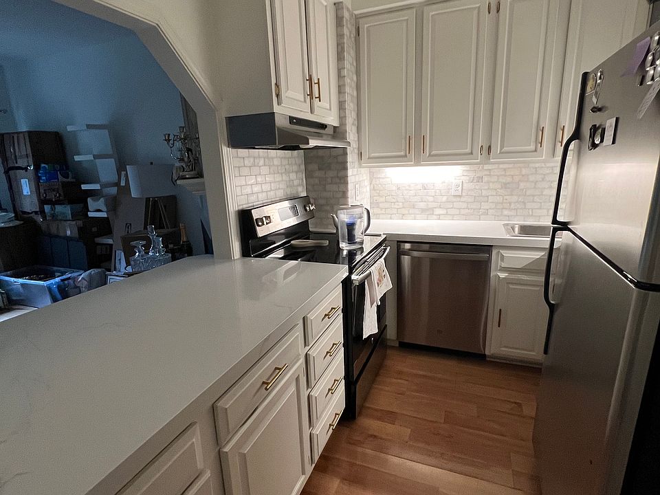 Recently updated backsplash and countertops. With freshly painted cabinets.