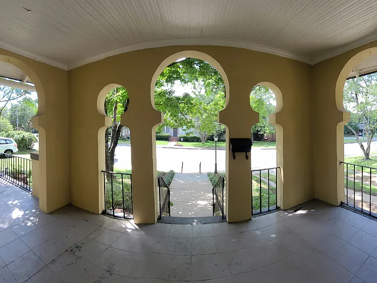 Front porch. Keyhole architectural feature frames nature for a serene view from inside windows.