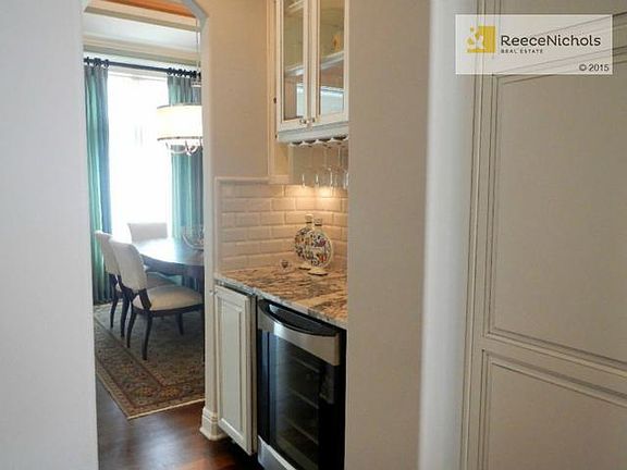 Convenient granite topped butler's pantry with refreshment refri