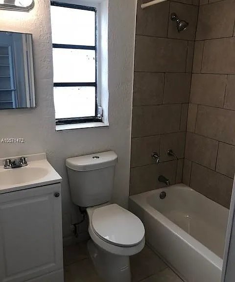 Traditional tiled bath-shower including tiled floor for easy upkeep. Some units have blue tiles.