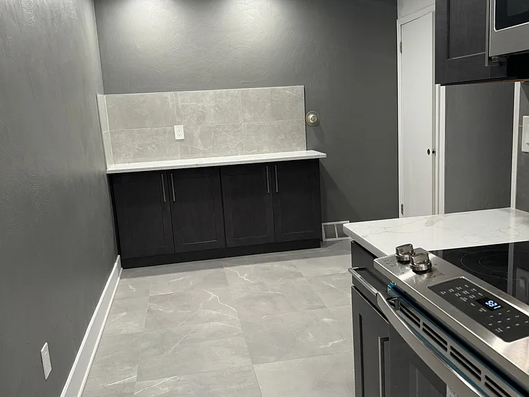 Kitchen table area with quartz counter top buffet.