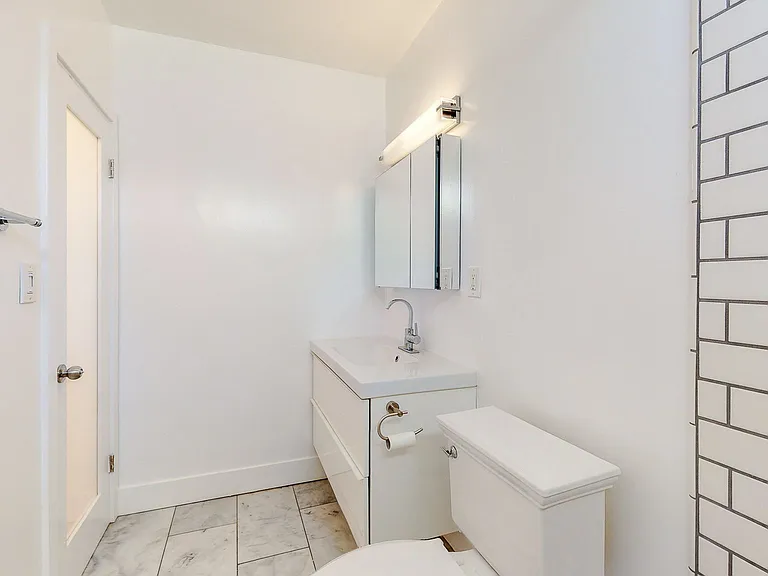 BATHROOM HAS LARGE SUBWAY TILE SHOWER W/ FULL BENCH