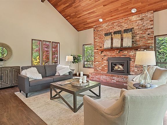 Living room with a gas fireplace. Large windows to enjoy the natural scene of four seasons