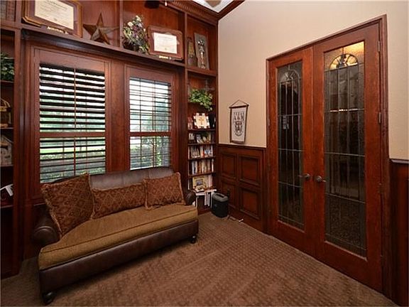 Study with leaded glass French doors, wainscot & built-ins.