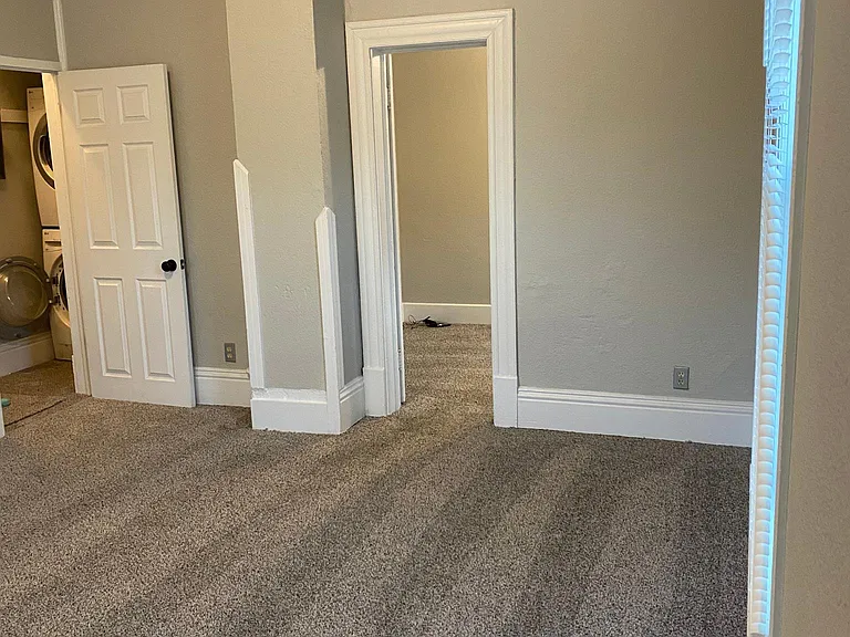 Bedroom, shared laundry access to second exit.
