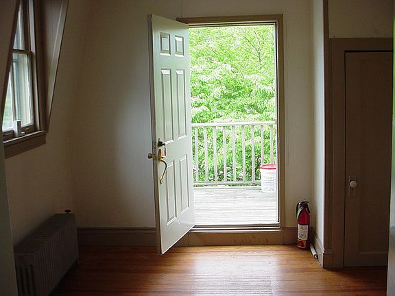 Entrance door looking out to the SMALL deck and privacy trees at the top of the stairs.