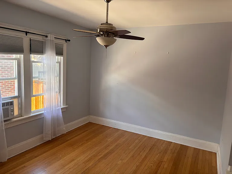 bedroom with steel attic stairs leading to more storage
