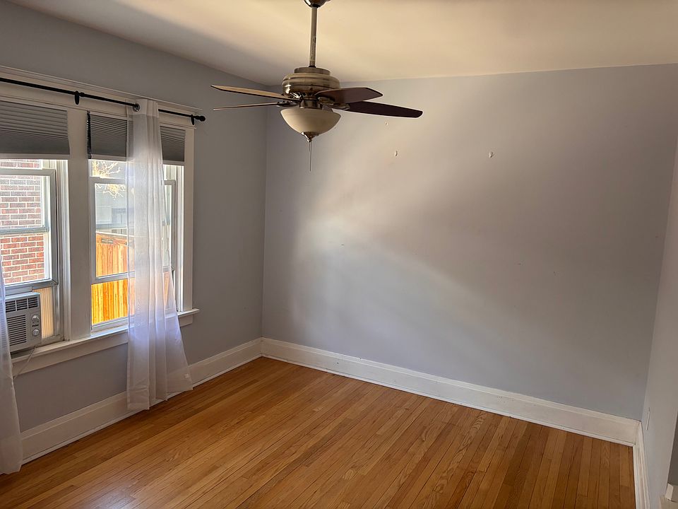bedroom with steel attic stairs leading to more storage