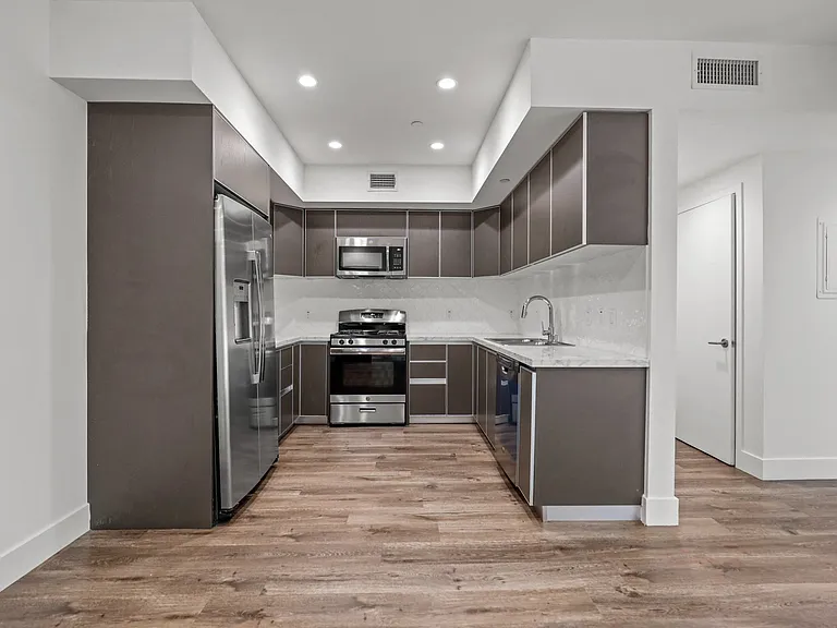 Kitchen with Energy-Efficient Appliances and Vinyl Flooring