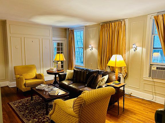 The apartment opens into the wood-paneled living room.