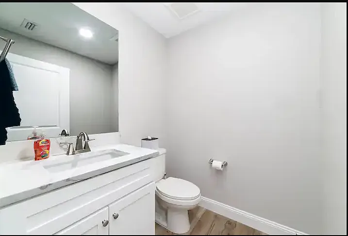 Half bath with single vanity and toilet.