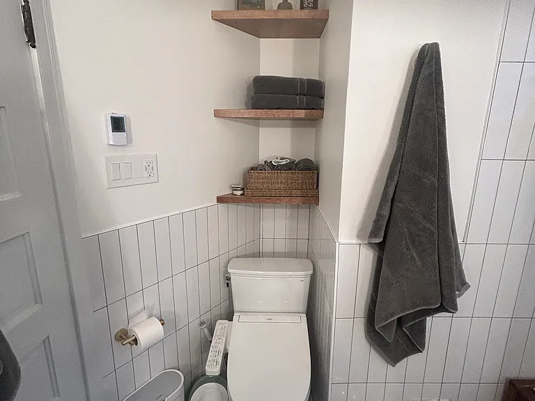 Bathroom built in storage shelving with Toto toilet & bidet; bathroom also has heated floors