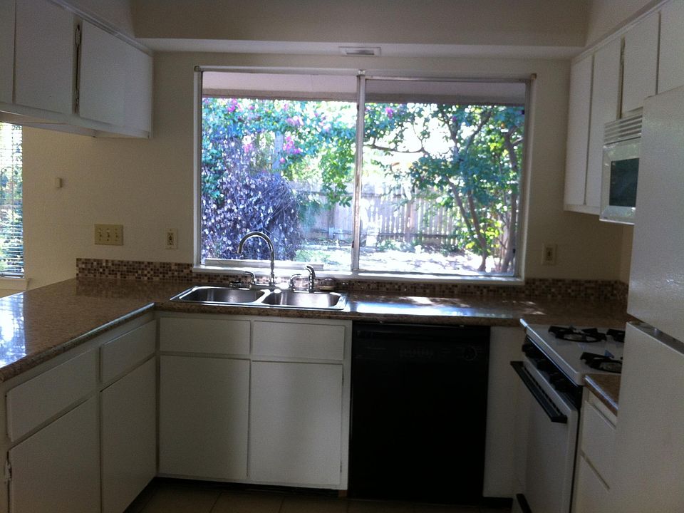 Open kitchen overlooking large fenced in back yard