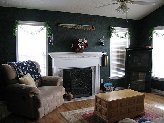 Beautifully decorated family room with wood-burning fireplace.