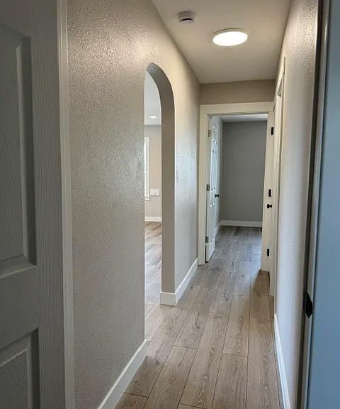 Hallway view from master bedroom. The left is the living room. The right is the newly renovated bathroom. Forward is the 2nd bedroom.