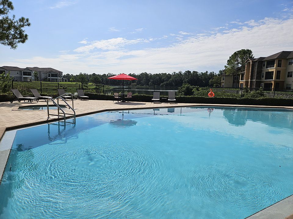 A clean, well-maintained pool with crystal-clear water_ perfect for swimming, relaxing, or sunbathing. Features include a spacious deck, lounge chairs, and both shallow and deep areas for all ages.