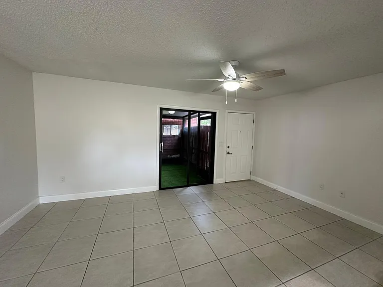 LIVING ROOM,
VIEW FROM NOOK AREA LOOKING AT THE FRONT DOOR AND SLIDING DOOR.