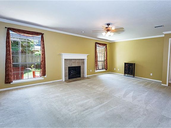 Den with gas log fireplace & crown molding