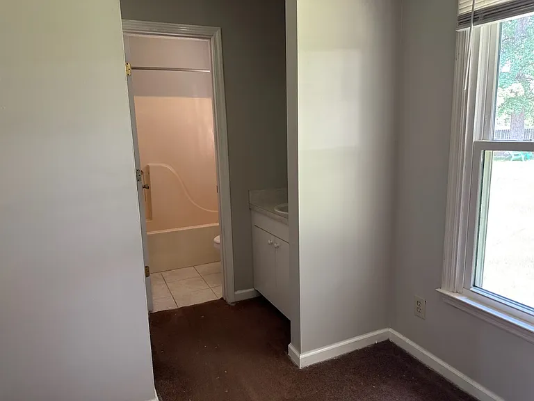 Bathroom off master bedroom has a single sink and the toilet and shower has a door to close. New flooring to be installed 10 July.