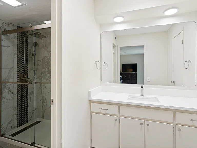 master bath with new quartz counter top, tile shower and fixtures