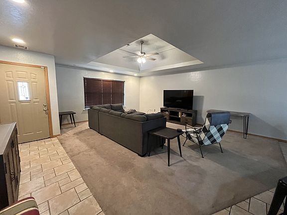 Living room open to kitchen and entryway