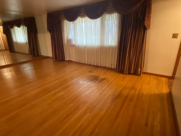 Living room - Curtains reflected off the wall mirror.