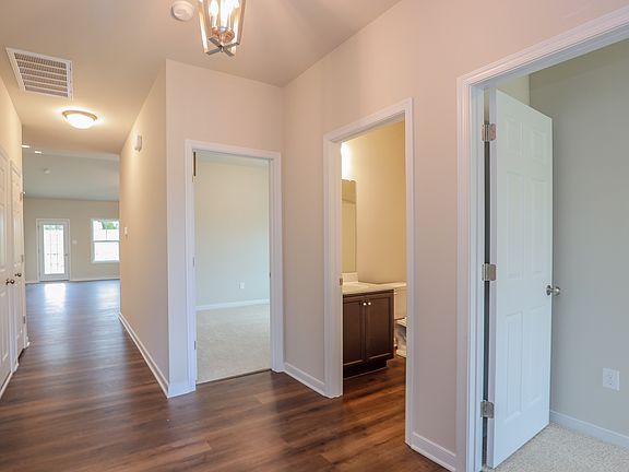 Bright hallway with wooden floors, leading to living and bedrooms-perfect for new homes in Richmond