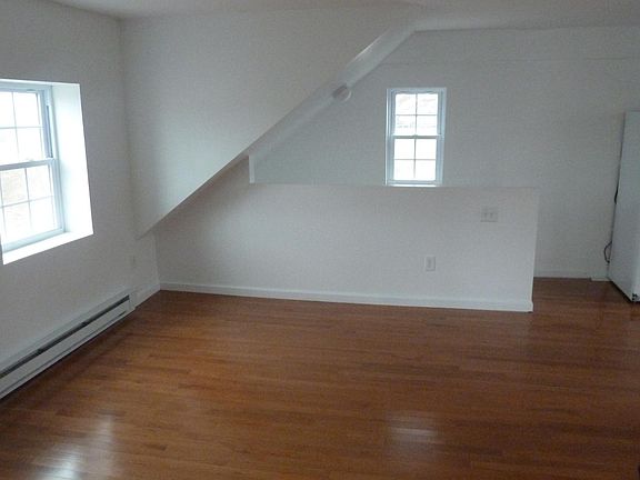View of the open living room - there is a closet directly behind the camera. The kitchen is on the right.