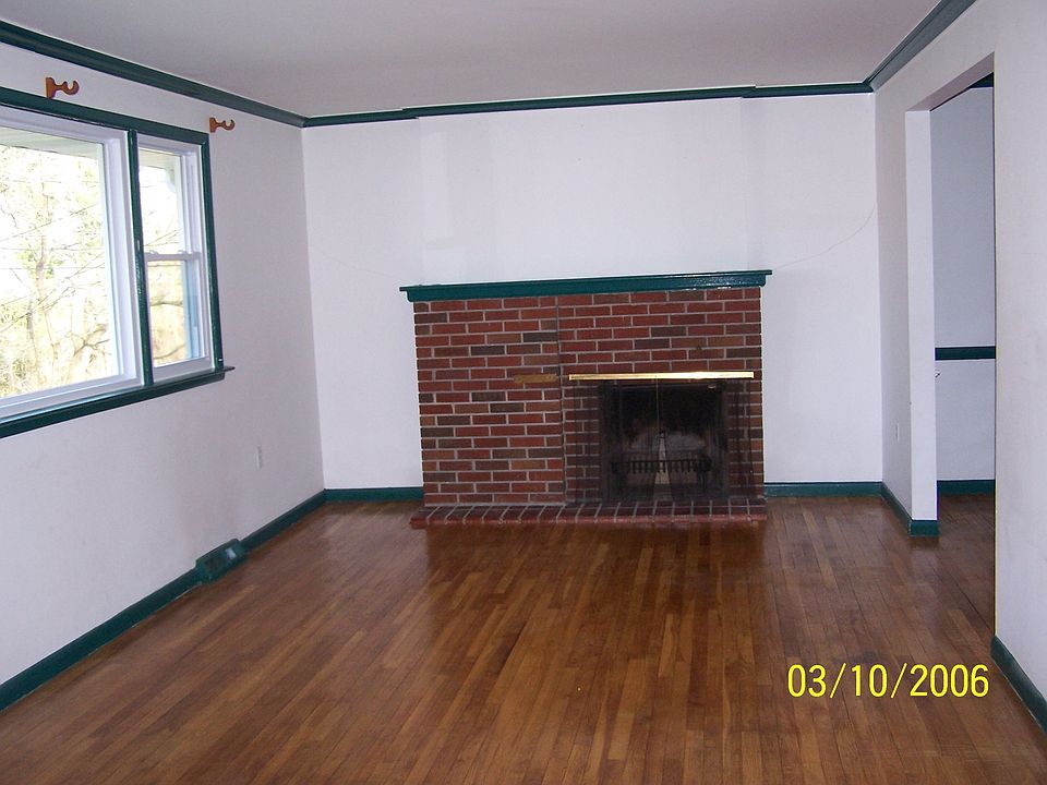 Famliy Room With Fire Place and Hardwood Flooring